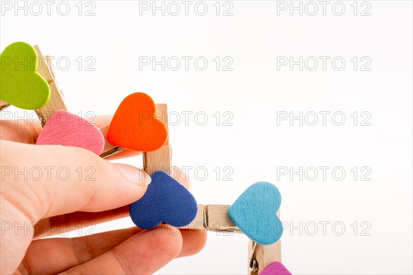 Colorful clothespin attached one another in hand form a zigzag