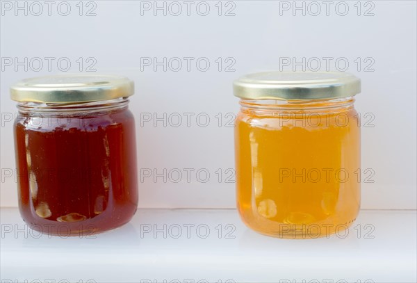 Glass jar of full of fresh honey with lid