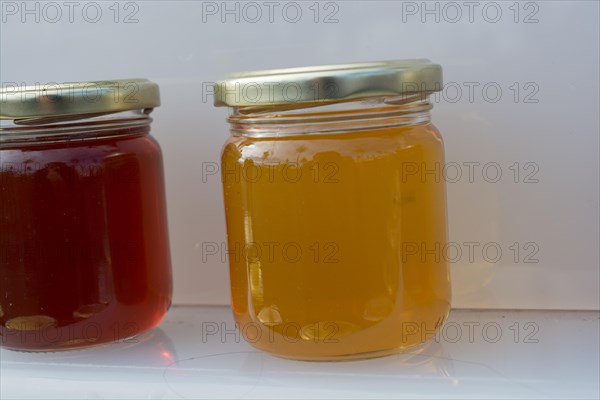 Glass jar of full of fresh honey with lid