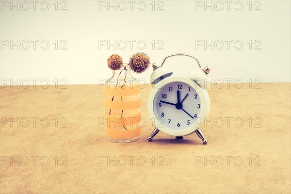 White color alarm clock on brown background