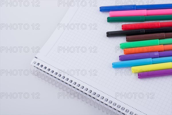 Colorful felt-tip pens on a notebook