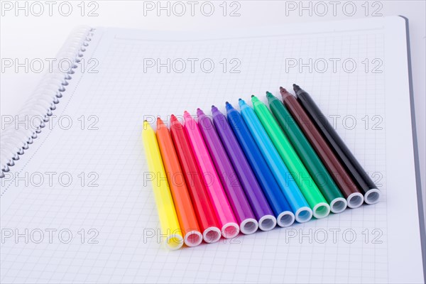 Colorful felt-tip pens on a notebook