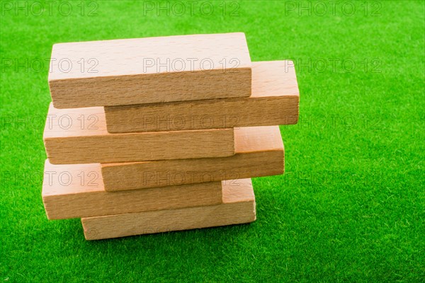 Wooden dominos on green grass