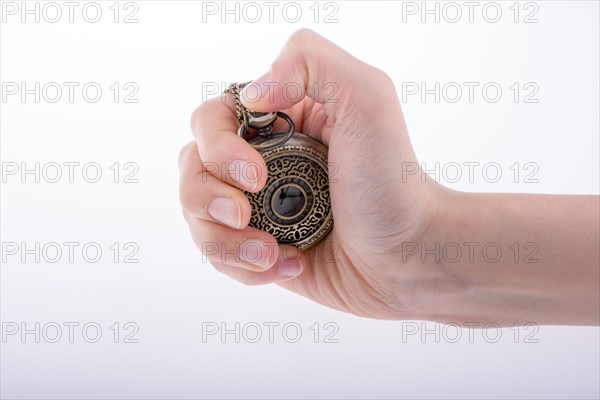 Hand holding a retro styled pocket watch in hand