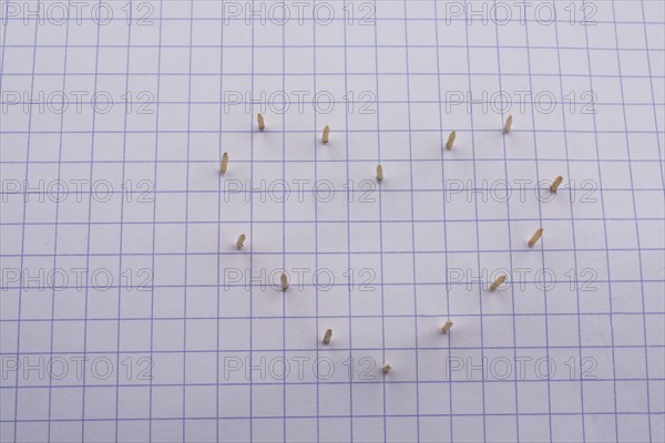 Nails make hole on paper forming a heart shape