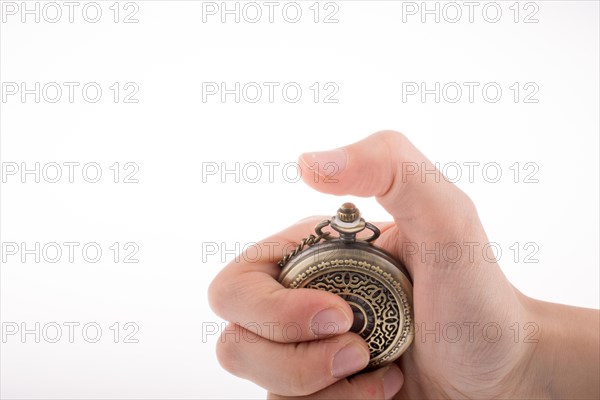 Hand holding a retro styled pocket watch in hand