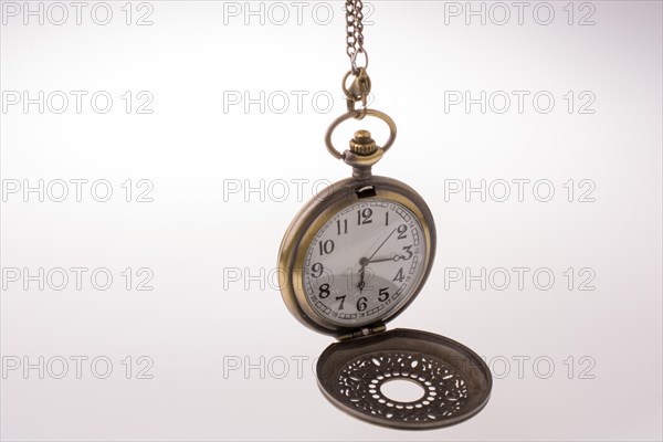 Retro style pocket watch on white background