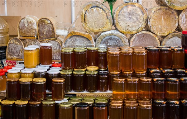 Glass jar of full of fresh honey with lid