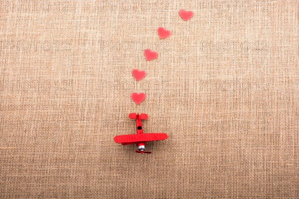 Heart shaped objects behind an red model airplane