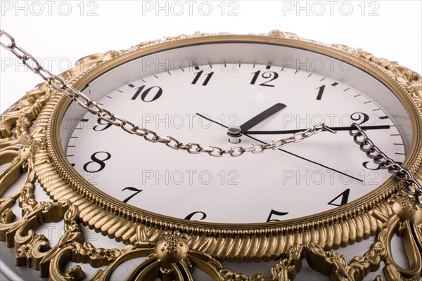Chained clock on a white background
