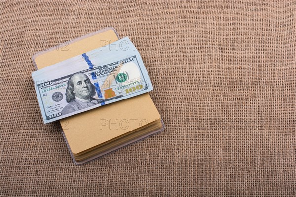 Banknote bundle of US dollar placed on a linen canvas
