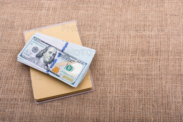 Banknote bundle of US dollar placed on a linen canvas