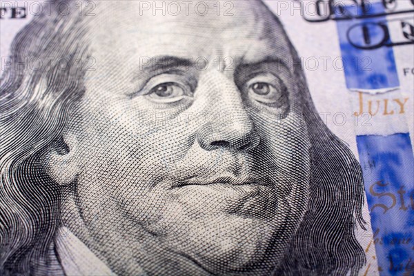 Close up of Benjamin Franklin face on 100 US dollar bill