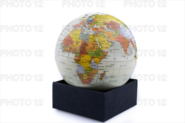 Little model globe put on a black box on a white background