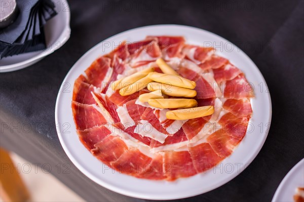 Dish with Iberico ham cut ready to eat