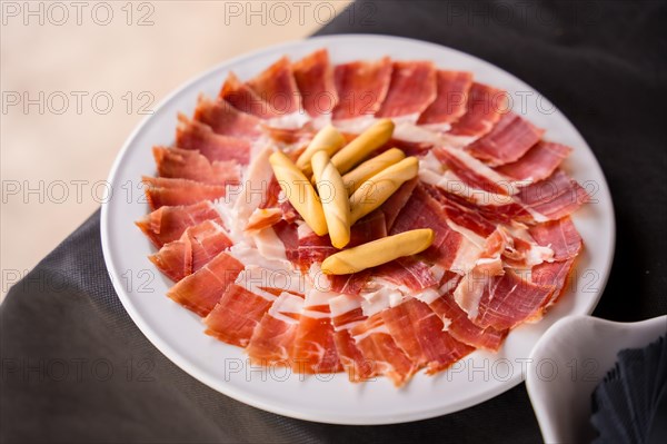 Dish with Iberico ham cut ready to eat