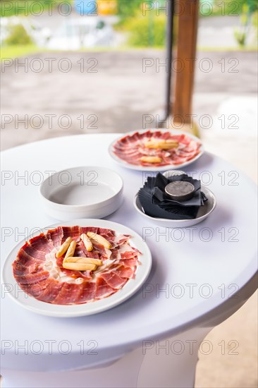 Dish with Iberico ham cut ready to eat