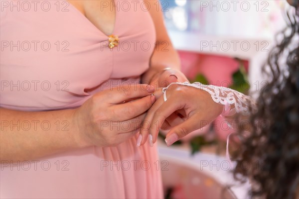 Mother placing a ring on her daughter on her 15th birthday