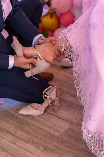 Father putting the shoes on his daughter on her 15th birthday