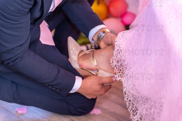 Father putting the shoes on his daughter on her 15th birthday