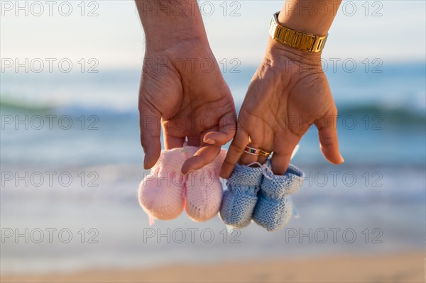 Pregnant maternity latin woman on the beach at sunset