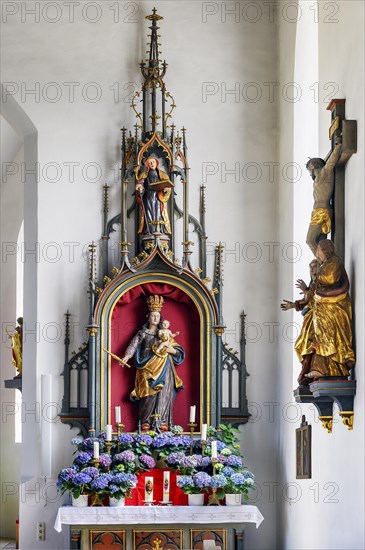 Side altar and figure of Mary with crown and baby Jesus in the church of St Michael