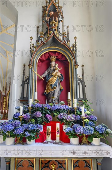 Side altar and figure of Mary with crown and baby Jesus in the church of St Michael