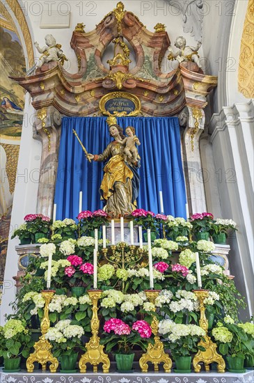 Side altar with figure of the Virgin Mary and floral decoration