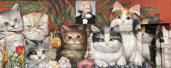 Street art by an unknown artist showing many cats with a portrait of Karl Marx