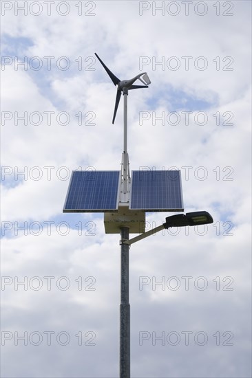 Street lamp with solar panels and small wind turbine