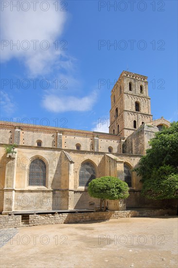 Inner courtyard with church tower of the Romanesque monastery Cloître St-Trophime