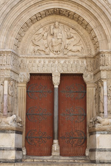 Portal with tympanum of the Romanesque St-Trophime Cathedral