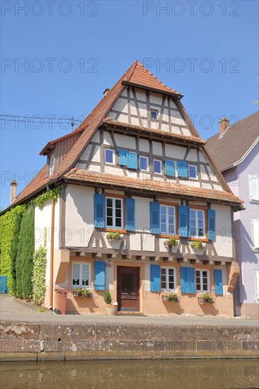 Historic half-timbered house with blue shutters