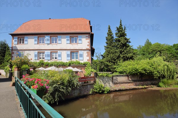 Historic half-timbered house Restaurant Caveau du Chatelet on the Lauter stream