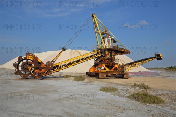 Bucket-wheel excavator wheel excavator at a salt mine with salt mountain for salt extraction