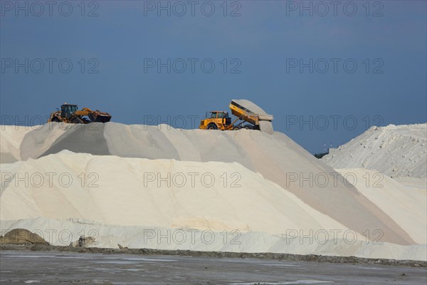 Dump truck unloading salt at a salt mine for salt extraction