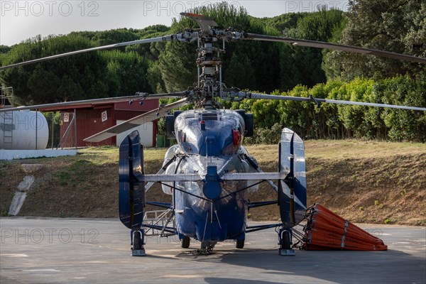 Firefighting helicopter parked at the heliport waiting for a forest fire warning