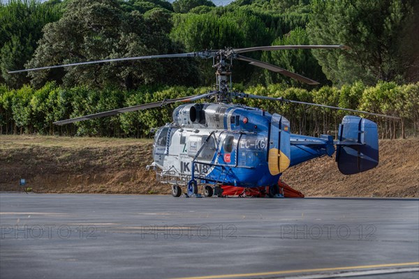 Firefighting helicopter parked at the heliport waiting for a forest fire warning