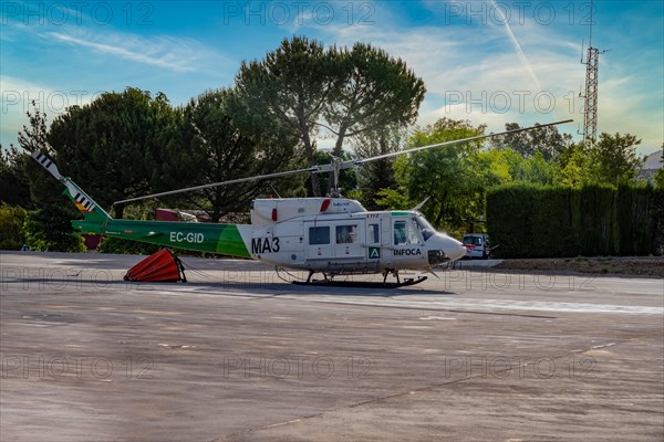 Firefighting helicopter parked at the heliport waiting for a forest fire warning