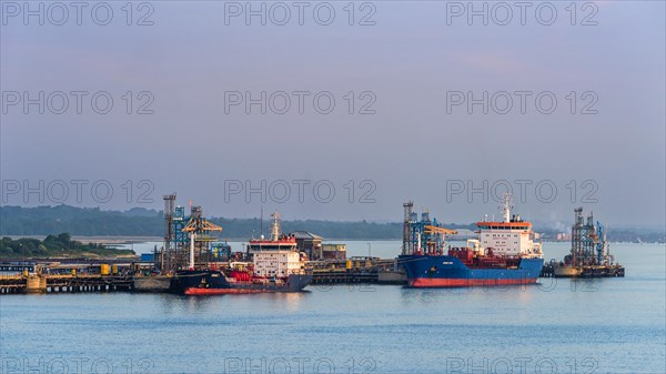 Sunrise over Gas tankers and Esso Oil Terminal