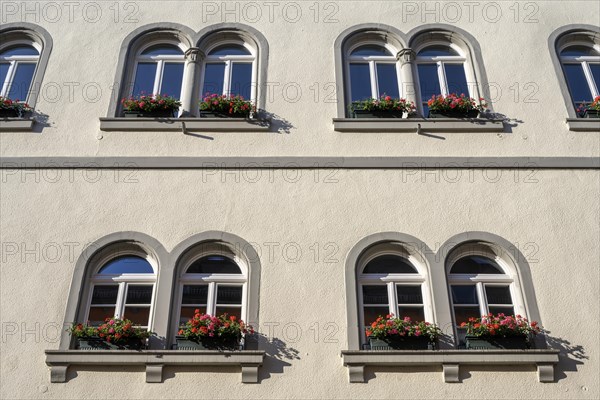 Arched window with decorative flower boxes on a town house in the old town of Radolfzell on Lake Constance
