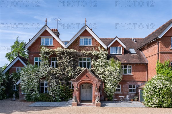 Entrance area of The Riverside Hotel in country house style with scarlet firethorn