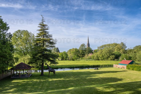 View over the parkland Queen Elizabeth Gardens to Salisbury Cathedral with the 123 m high and Britain's highest church tower