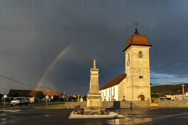 Thunderstorm with rainbow over the Church of the Nativity Église de l'Assomption in Les Plains-et-Grands-Essarts