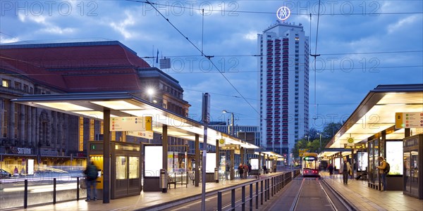 Early morning tram stop at the main station with winter garden high-rise