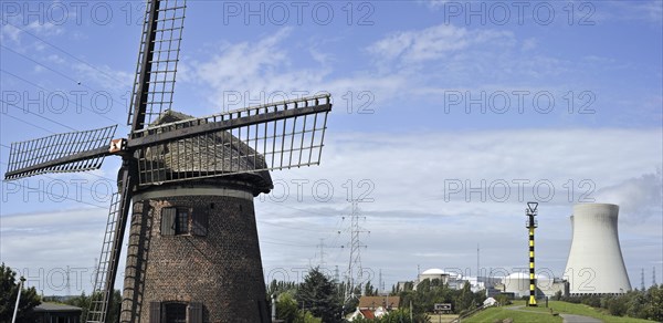 The windmill Scheldedijkmolen and cooling towers of the Doel Nuclear Power Station along the river Scheldt at Kieldrecht