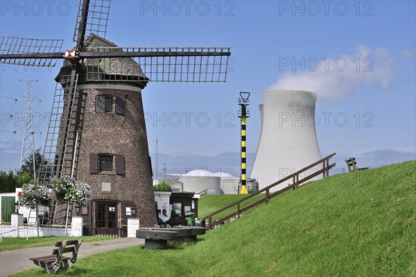 The windmill Scheldedijkmolen and cooling towers of the Doel Nuclear Power Station along the river Scheldt at Kieldrecht