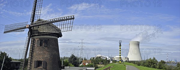 The windmill Scheldedijkmolen and cooling towers of the Doel Nuclear Power Station along the river Scheldt at Kieldrecht