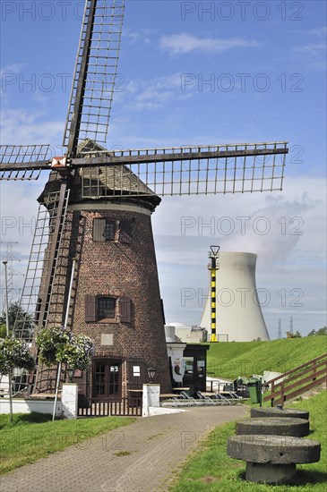 The windmill Scheldedijkmolen and cooling towers of the Doel Nuclear Power Station along the river Scheldt at Kieldrecht