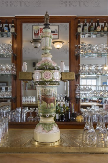 Vintage ceramic draft beer tap with two faucets in café In den Grooten Moriaen